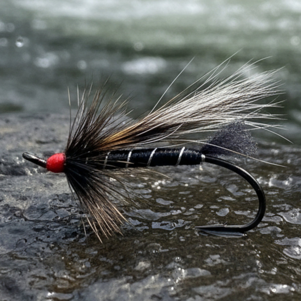 Fishing fly with black and red details on a textured white background