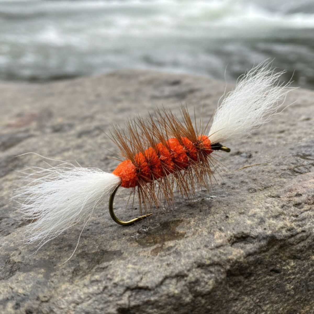 Atlantic Salmon Bomber with orange body, white wing and tail and a brown hackle