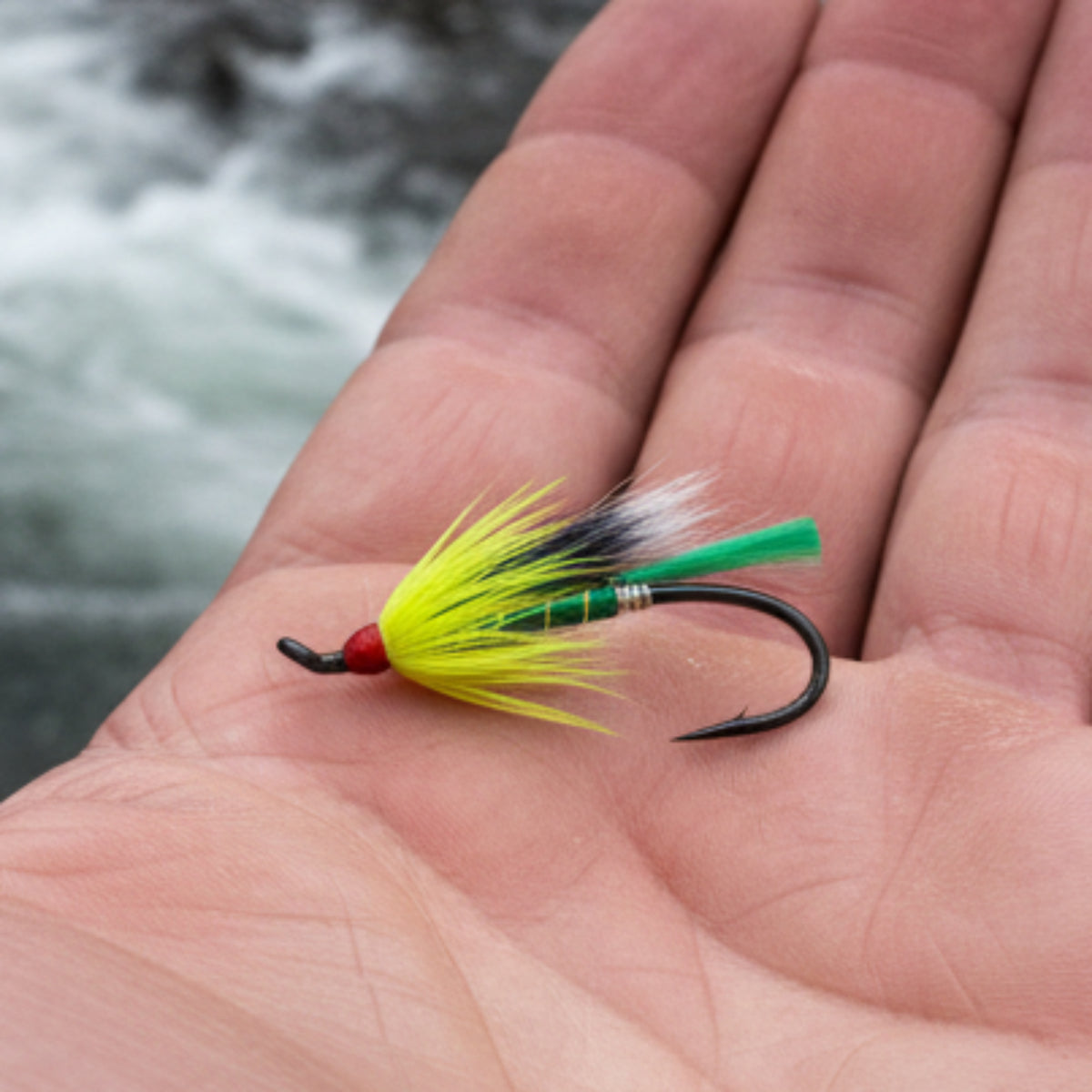 Fishing lure with green and black details on a white background