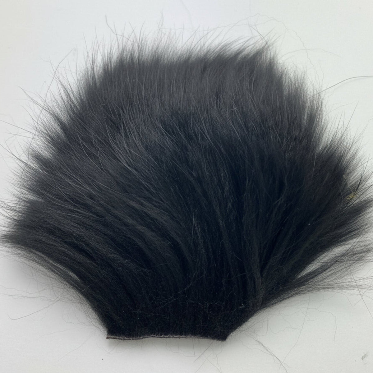 Black fur piece on a white background