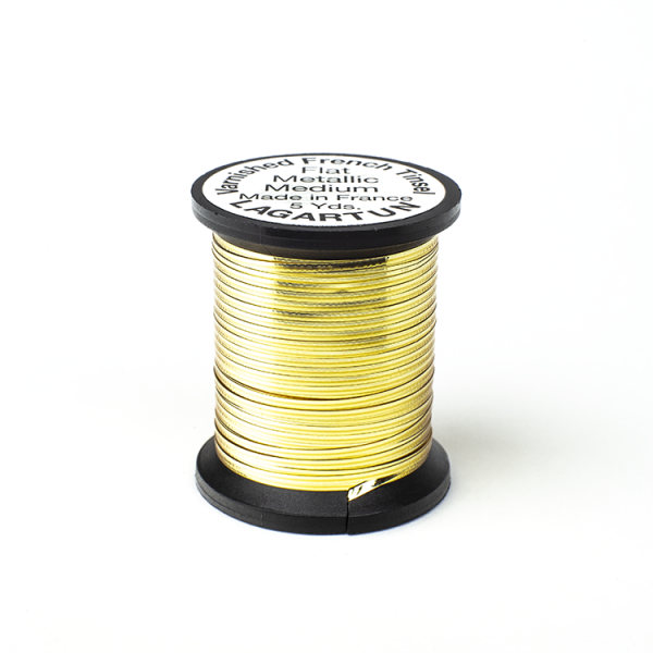 A spool of Lagartun Flat Varnished Tinsel with a metallic gold finish, used for fly tying in fishing.