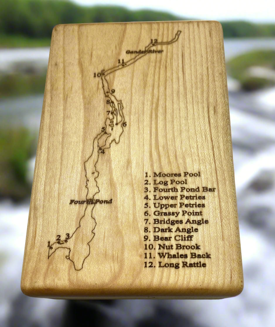 Wooden box with laser-engraved map and text on a white background