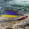 fishing fly. purple, yellow and white with a silver body
