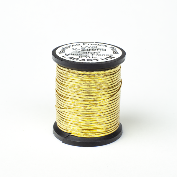 A spool of Lagartun French Varnished Oval Tinsel with a gold-colored metallic finish, used for fly tying in fishing.