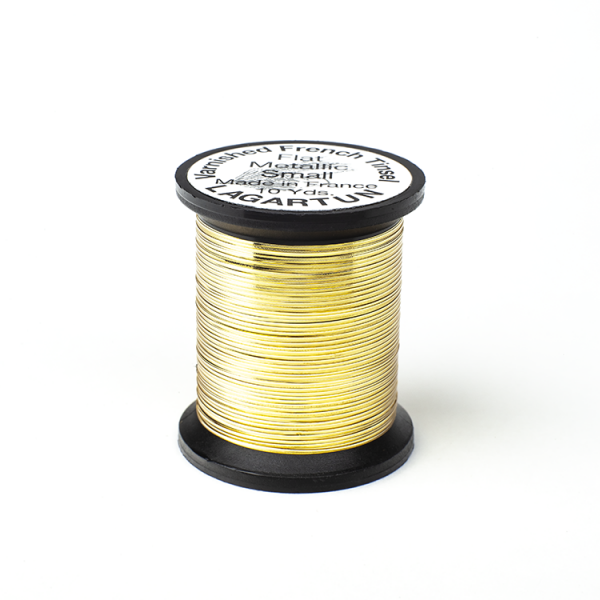 A spool of Lagartun Flat Varnished Tinsel with a metallic gold finish, used for fly tying in fishing.