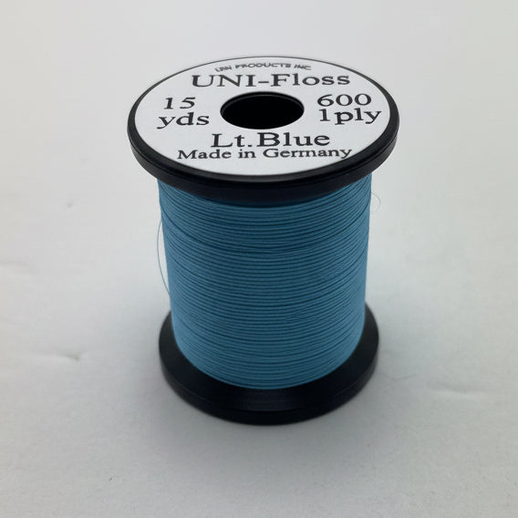 A spool of light blue sewing thread labeled UNI-Floss 600 1ply Lt. Blue, made in Germany, set against a plain off-white background.
