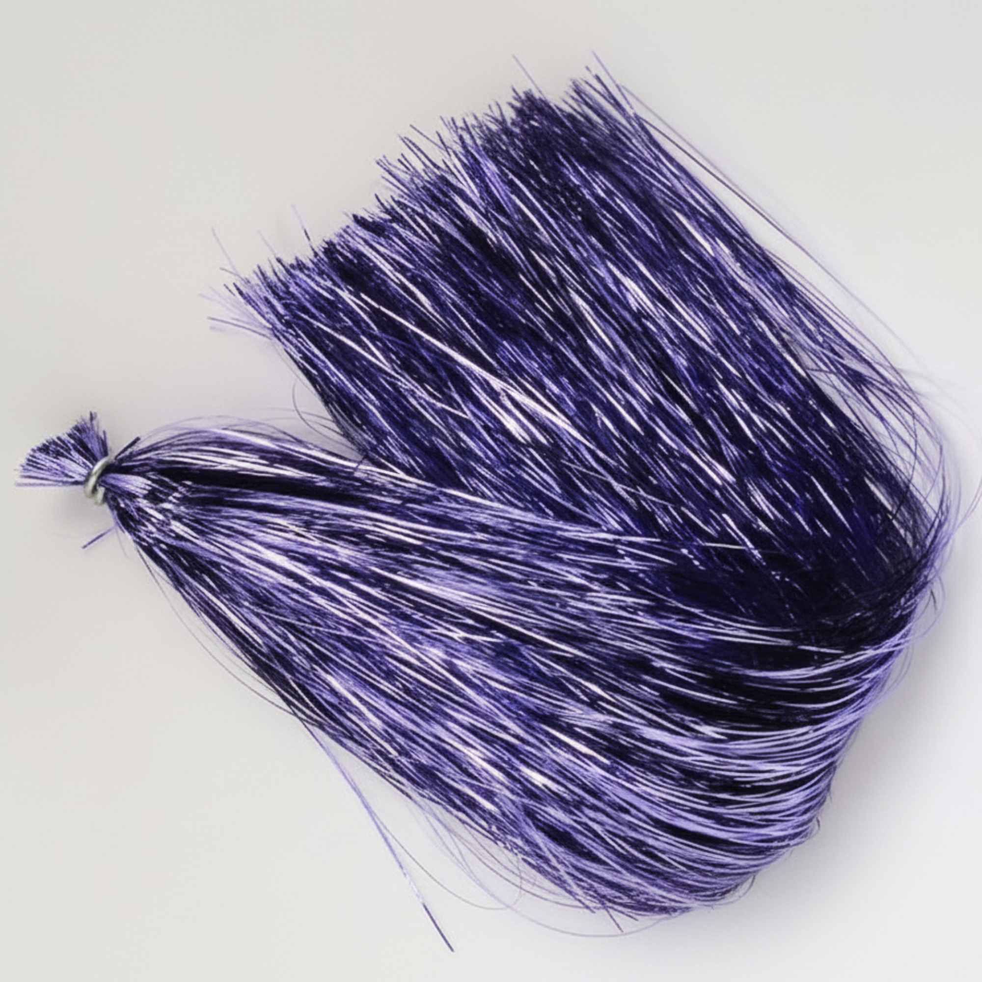 Purple tinsel strands on a white background