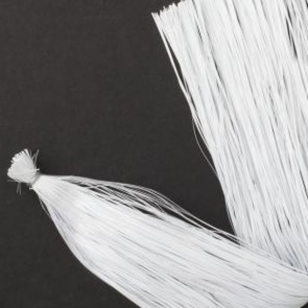 White tassels on a black background