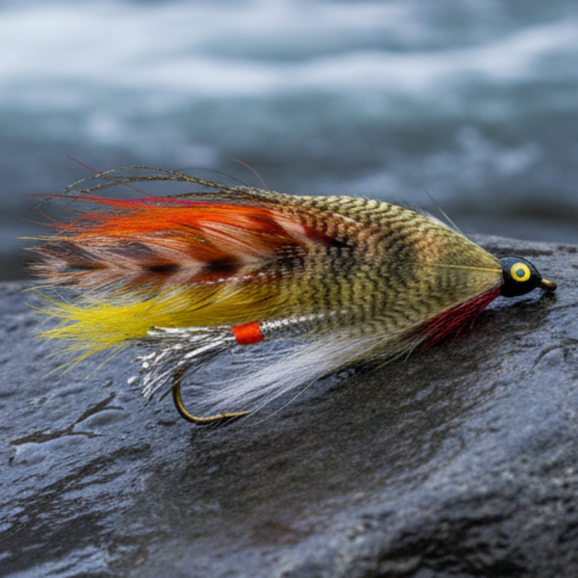 Streamer Fly. Silver body with yellow and orange wing