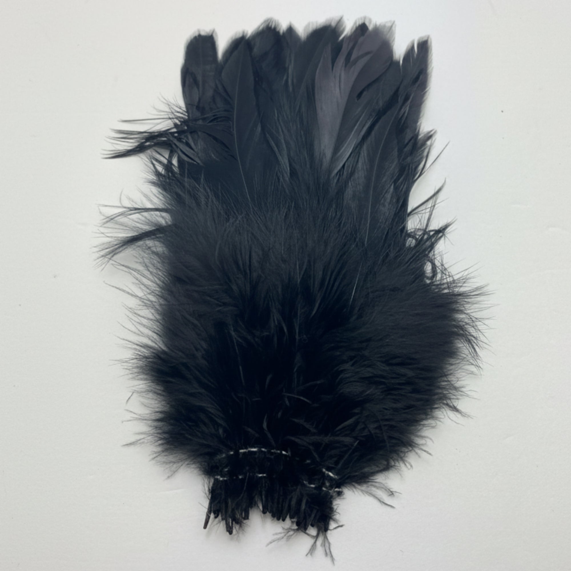 Black feathered product on a white background