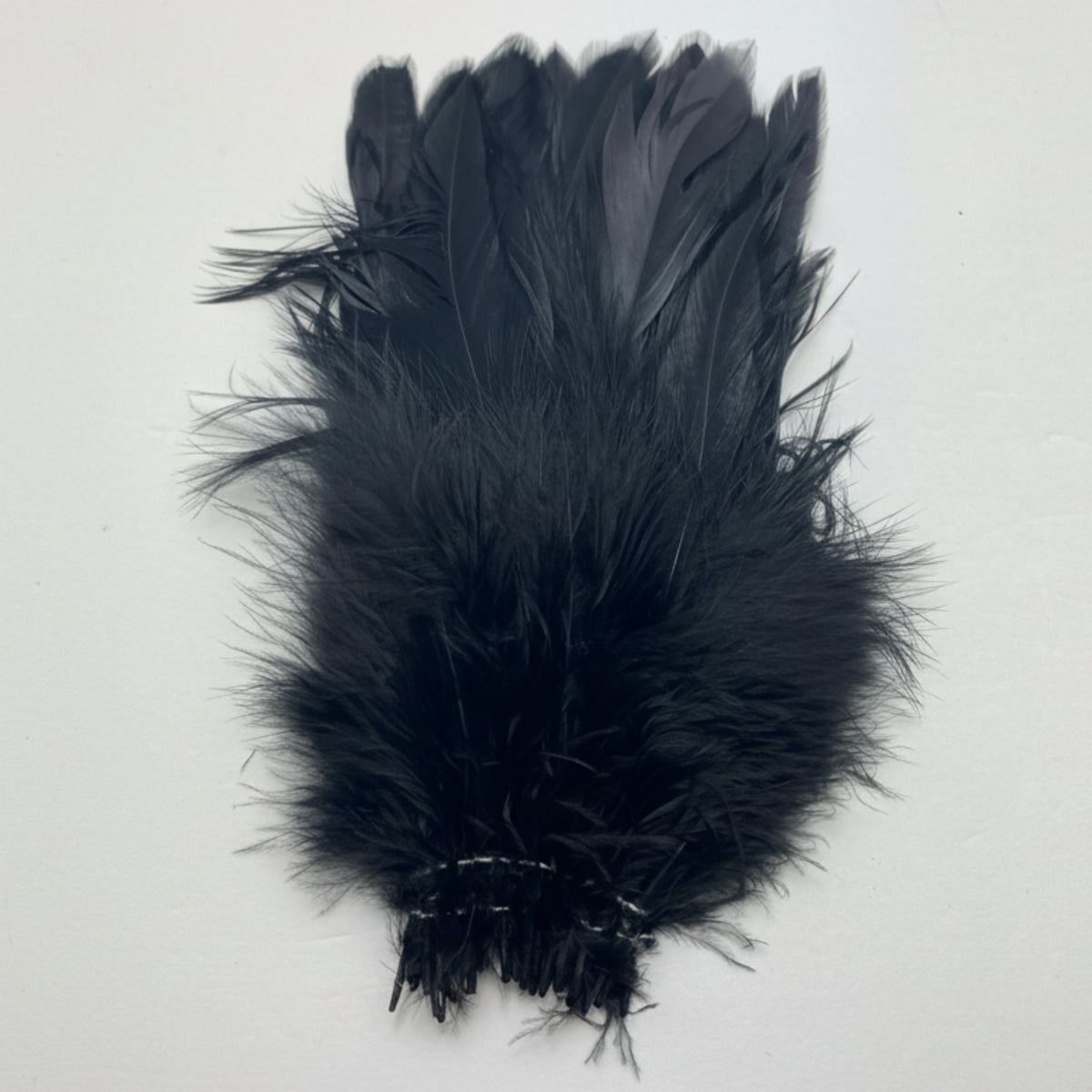 Black feathered product on a white background