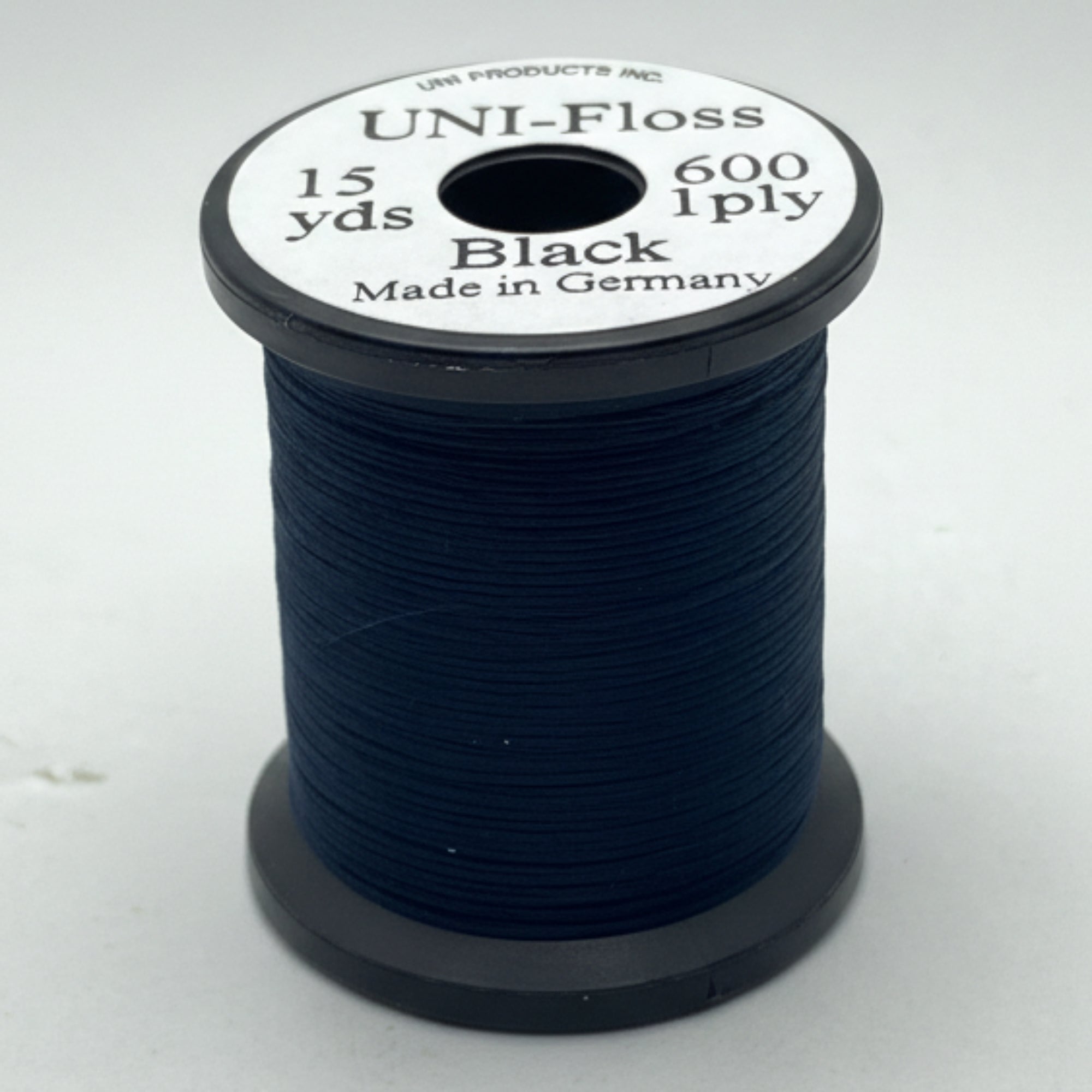 Spool of black thread with label on a white background