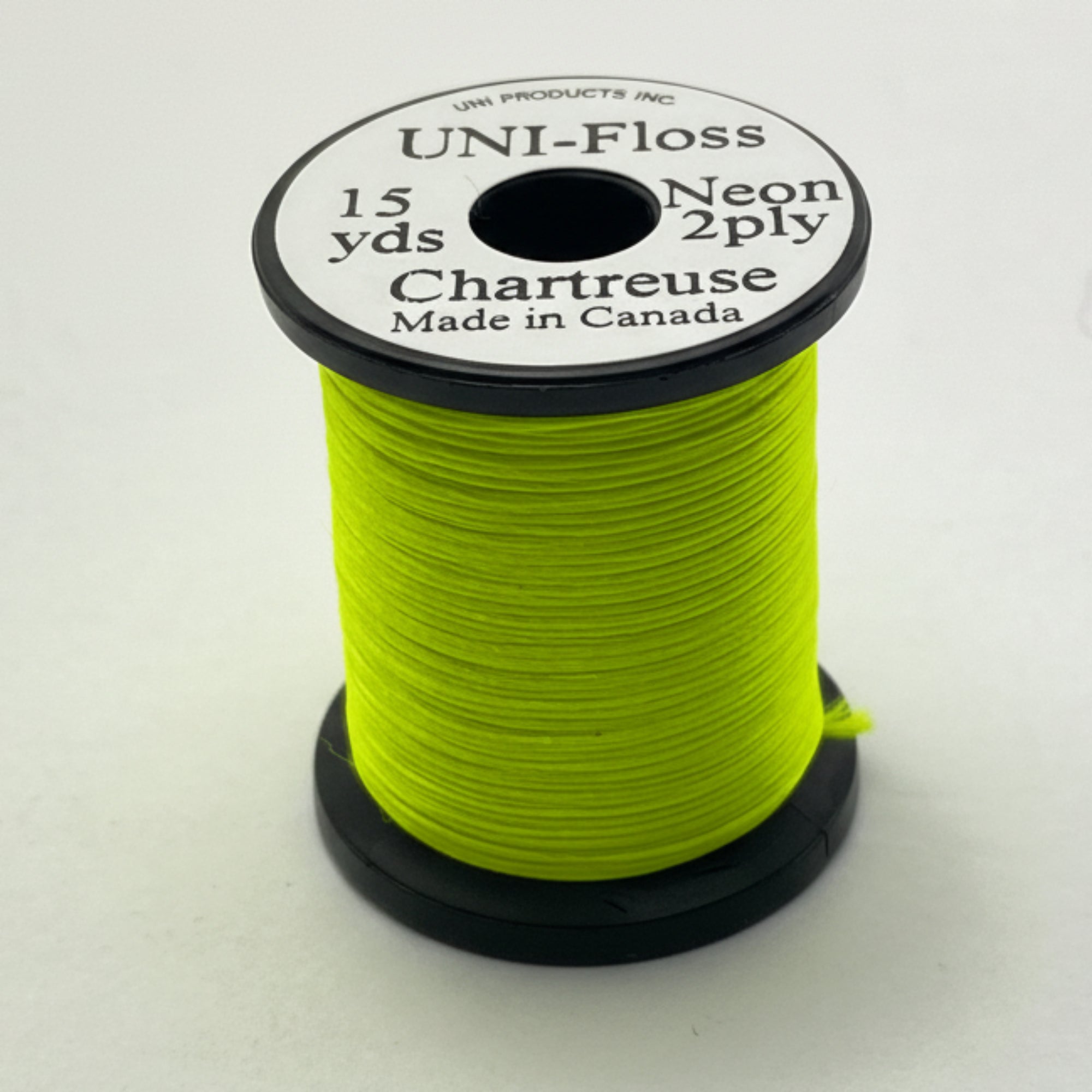Spool of green thread with a label on a white background