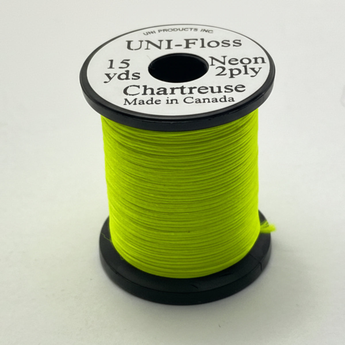 Spool of green thread with a label on a white background