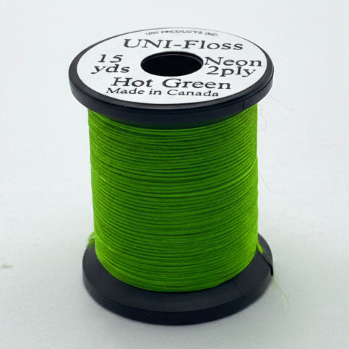 Spool of green thread with a label on a white background