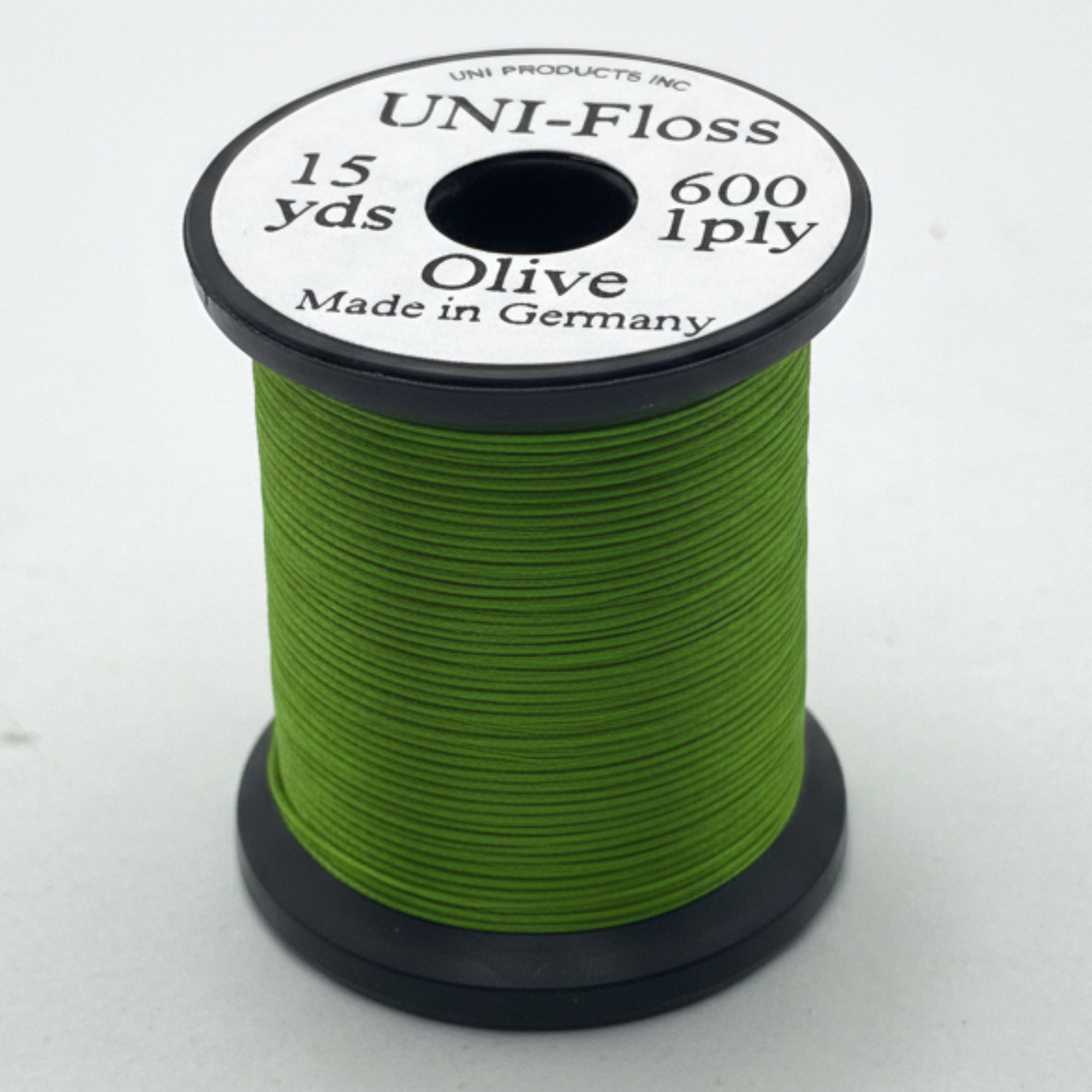 Spool of green thread with a label on a white background