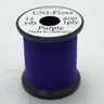 Spool of purple thread with a white label on a light gray background