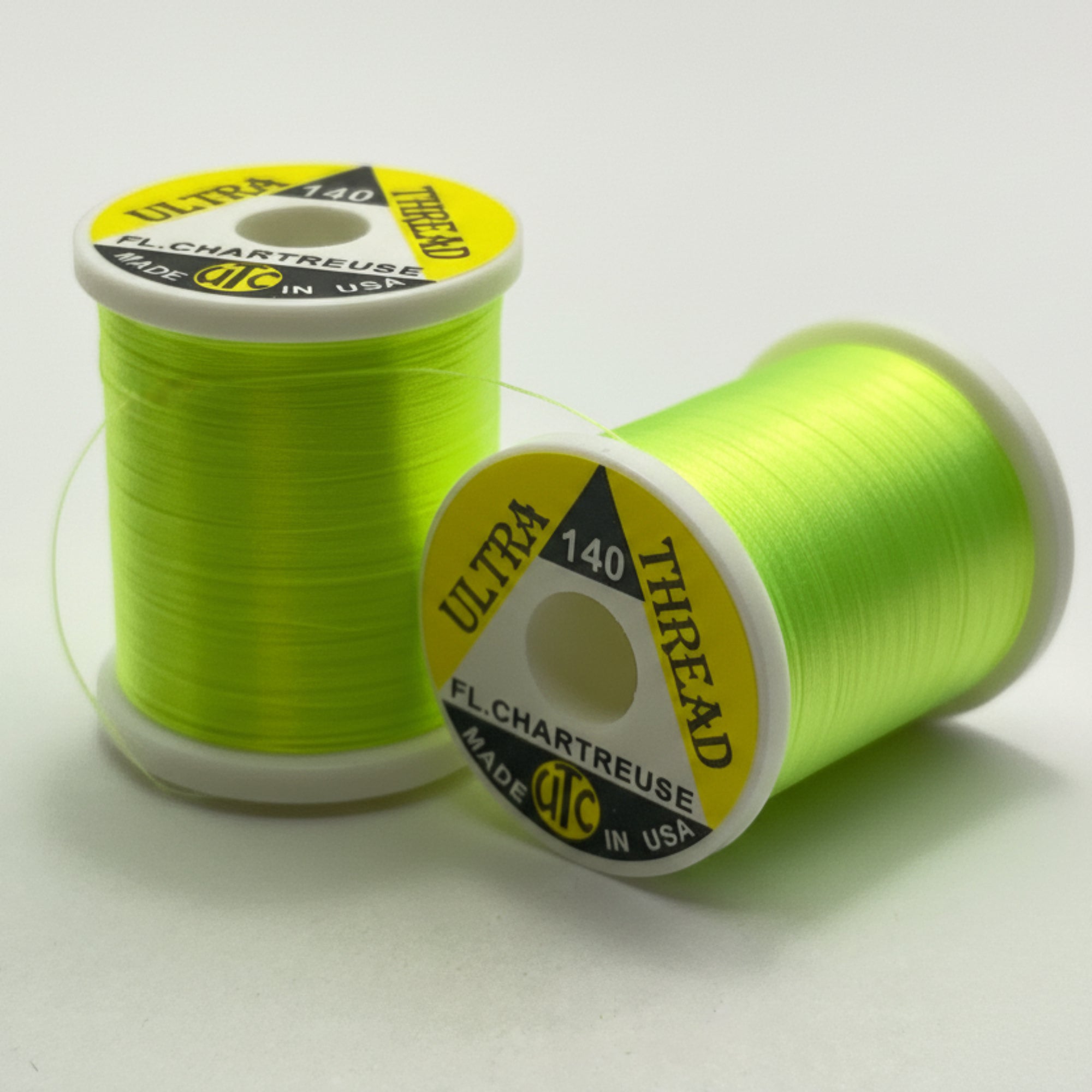 Two spools of chartreuse thread with visible branding on a white background