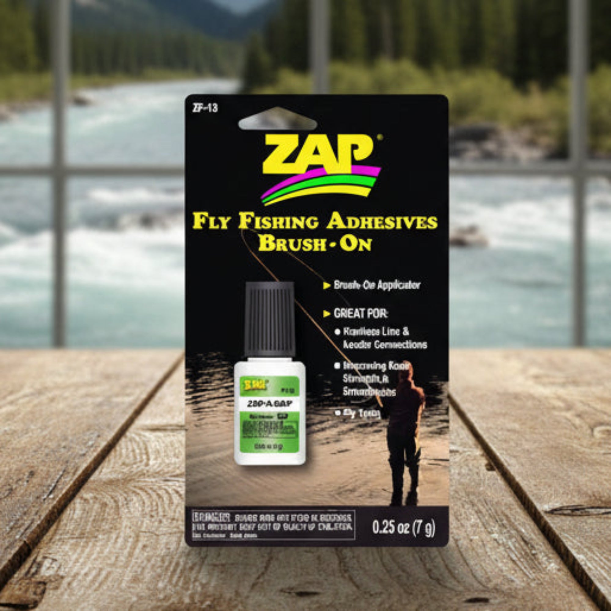 Packaging for Zap-Brush On fly fishing adhesives with a picture of a person fly fishing and a brush applicator bottle.